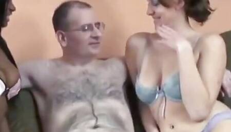 Two sexy interracial bitches suck cock of hairy stud indoors