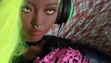Ebony skinned sex doll masturbates with a joypad