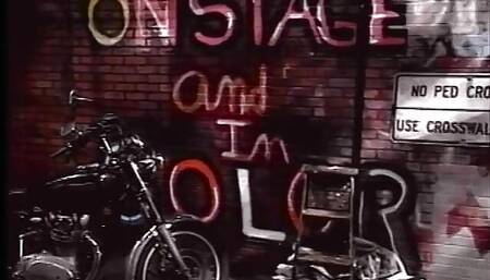 Biker chick fucks man in skull cap outside on the ground