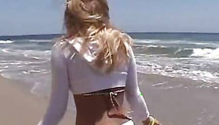 Petite teen lesbian fingered on the beach