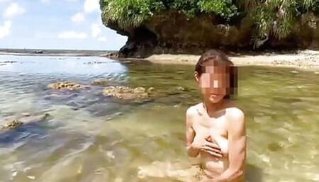 Naked on the Beach,She is Covered with sand.it's naked weather.