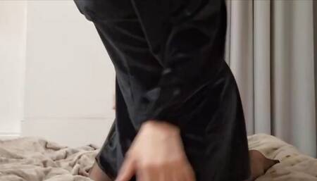 The cutie is lying on the bed pulling up her dress
