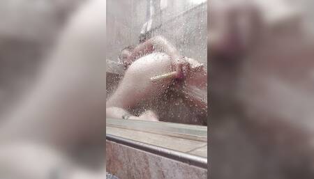 Dildo fucking my pussy while the water blasts my clit