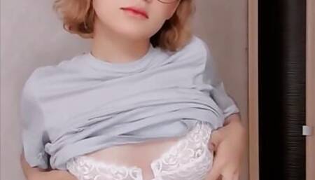 Hot white girl with glasses records a very sensual striptease on video