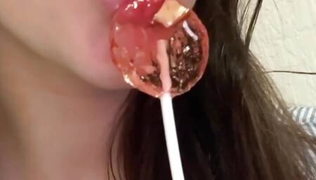 This lustful bitch sucks candy and dreams of a big dick