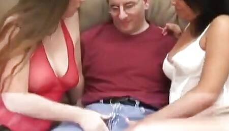 Tech guy gets it all with two girls gnawing on his cock on living room sofa