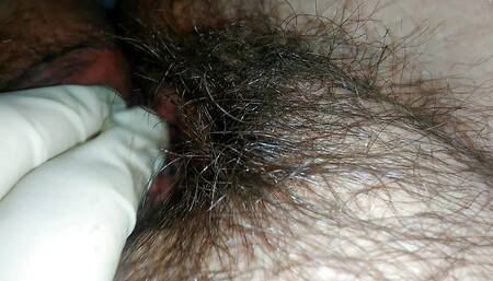 Hairy milf pampers her pussy with latex gloves