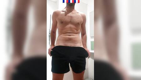 a young man shows his big hard cock before shower