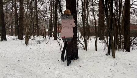 a girl walks through the winter forest in extremely high heels ballet boots