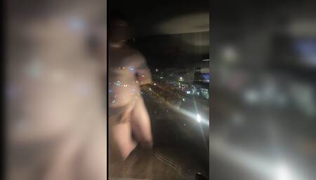 Standing Naked in Front of the Hotel Window Along a Busy Road