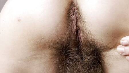 Mature MILF spread her hairy asshole and hairy pussy wide open, close-up