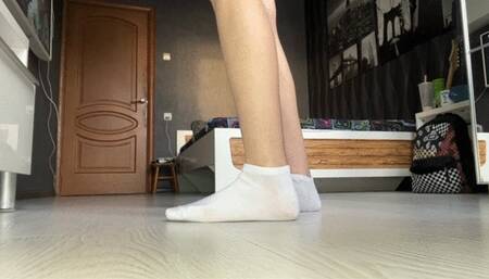 girl in a school uniform teases the viewer with her feet in socks, shows them close to the camera and plays with them, and then jerks off a toy