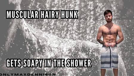 Muscular hairy hunk getting soapy in the shower