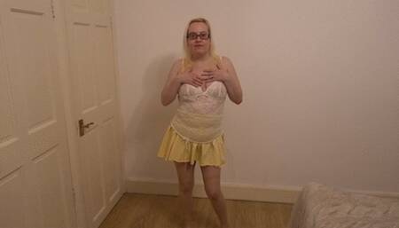 Dancing striptease in yellow miniskirt and pantyhose