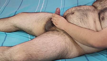 Bear man masturbating on a cyan bed