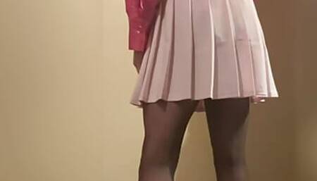 Young cute sissy in pink satin blouse and mini skirt
