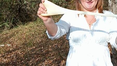 blowing big pink heart in park