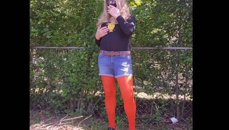 Crossdresser outdoors tease, smoking in nylon pantyhose.