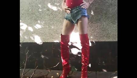 Slutty Cd Bella plays outside in red swimsuit and sexy boots