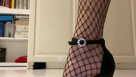Sensual female feet with Fishnet stockings stiletto heels