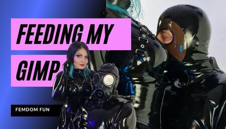 Femdom Rubber Goddess feeds her Gimp