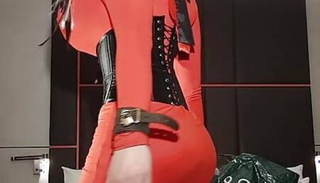 Busty sissy slut in bright orange dress and tight corset