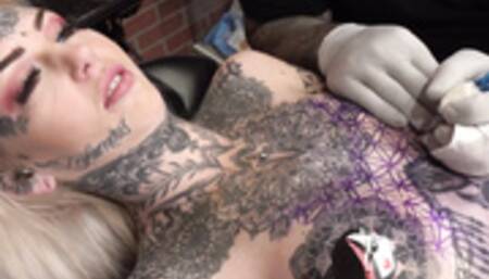 Sascha plays with Amber Luke while she gets tattooed