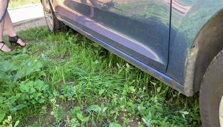 girl in high heels washes a car, her shoes and feet get wet