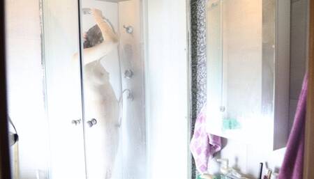 A girl caresses herself in the shower