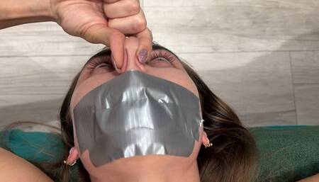 Pinches nose with fingers, mouth taped shut (fragment of custom video) part 2