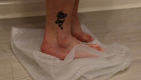 bubble wrap crush with bare feet and my new peep toe black high heel stilettos