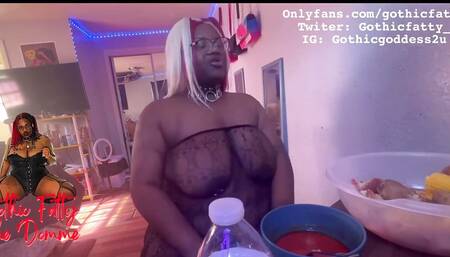 Ebony BBW stuffs her face while she is topless