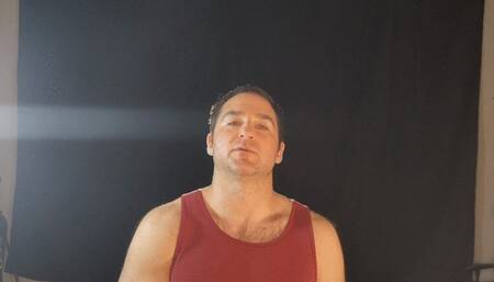 Guy smoking a Marlboro Red 100 in a tank top sexily