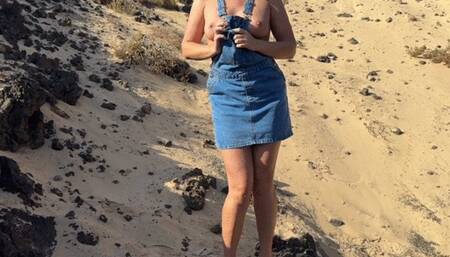 Girl pee in jeans skirt on the public beach