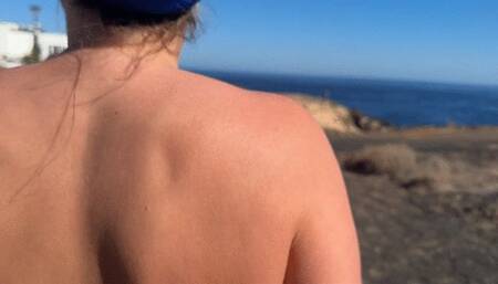 Girl is walking on the public beach and pee
