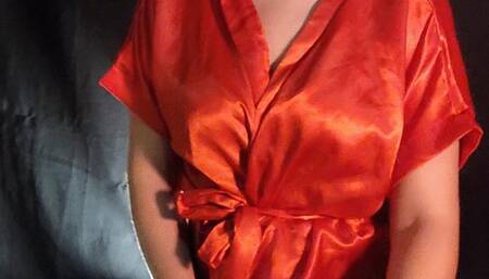 Smoking inhaling cigar wearing satin robe with all sensualidade that cigar deserves