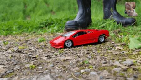 Red metal Car under black Wellies