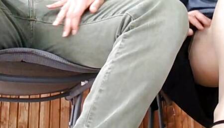 Under the table. The cheating wife invites the neighbor for a drink and  rides him