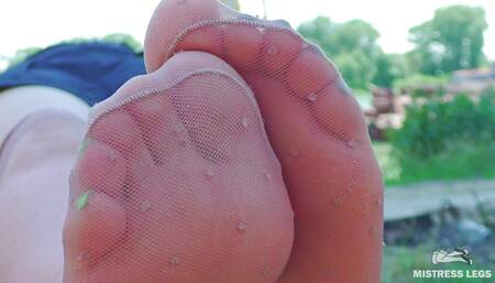 Cute feet in nylon knee socks and white socks teasing you closeup outdoor