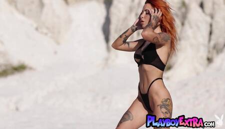 Naked red babe showing her sexy tattoos