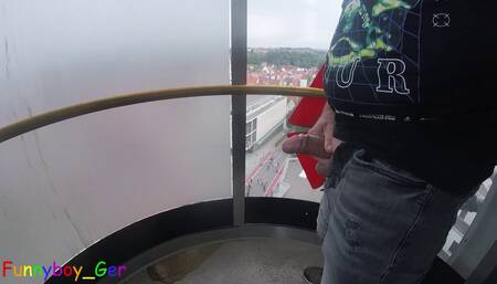 I jerk my cock very riskily in a public, transparent outdoor elevator on the 13th floor.