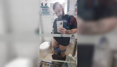 Hairy boy strips naked in front of the mirror and jerks off