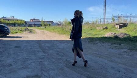 girl in high heeled shoes with open toes was waiting for her boyfriend, but when he drove by, he ran right into her toes