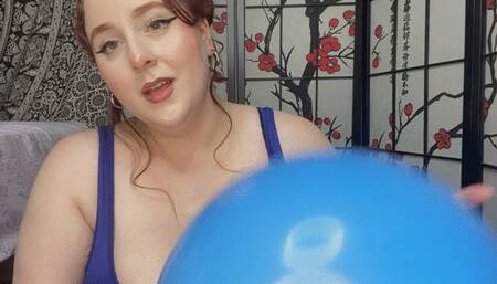 Blue balloon pops with a needle