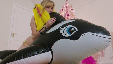 Alla inflates a big black whale and an airline life jacket with her mouth and hotly rides on a squeaky inflatable whale, getting pleasure
