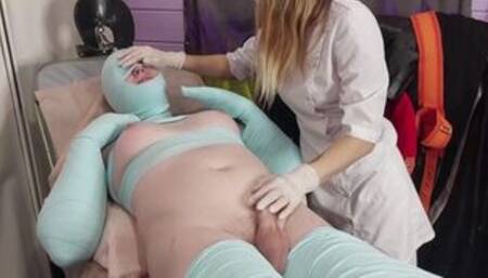Dominant nurse bondage TGirl patient with elastic bandages. Medical fetish restraining and exam.