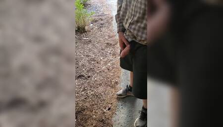 Boy Peeing Outside Cabin
