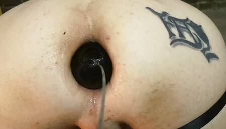 anal close-up insertion of a bakelite sphere with rod
