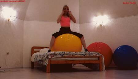 Alla happily jumps and does gymnastics on huge fitness balls