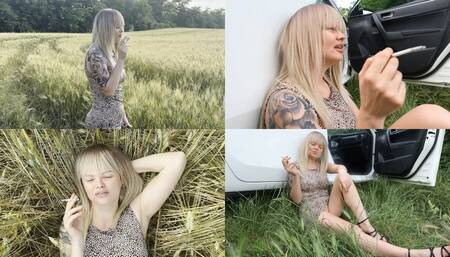 Blonde relaxes in nature and smokes 2 cigarettes